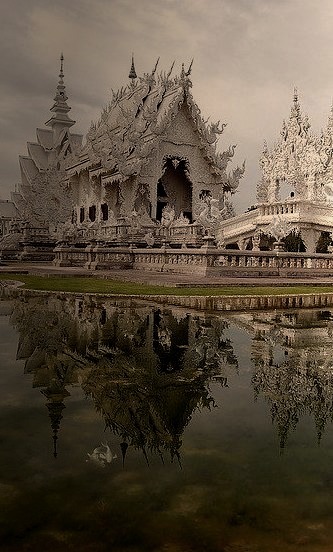Reflections of Wat Rong Khun in Chiang Rai, Thailand