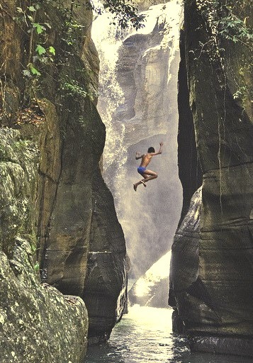 Jumping into the waters of Cunca Wulang Canyon, Flores, Indonesia